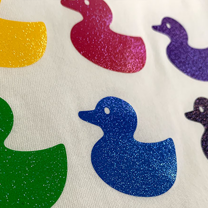Prisma Sparkleshine Heat Transfer Vinyl on a design of rainbow rubber duckies.