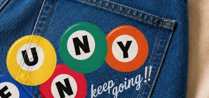 Jeans back pocket with full color DTF letter discs and a keep going script
