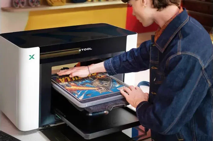 A full color print going straight onto a dark tee on the xTool O1 Garment Tray